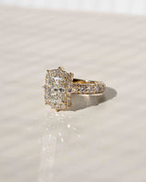 Rococo halo offers a gorgeous frame to your radiant-cut center diamond