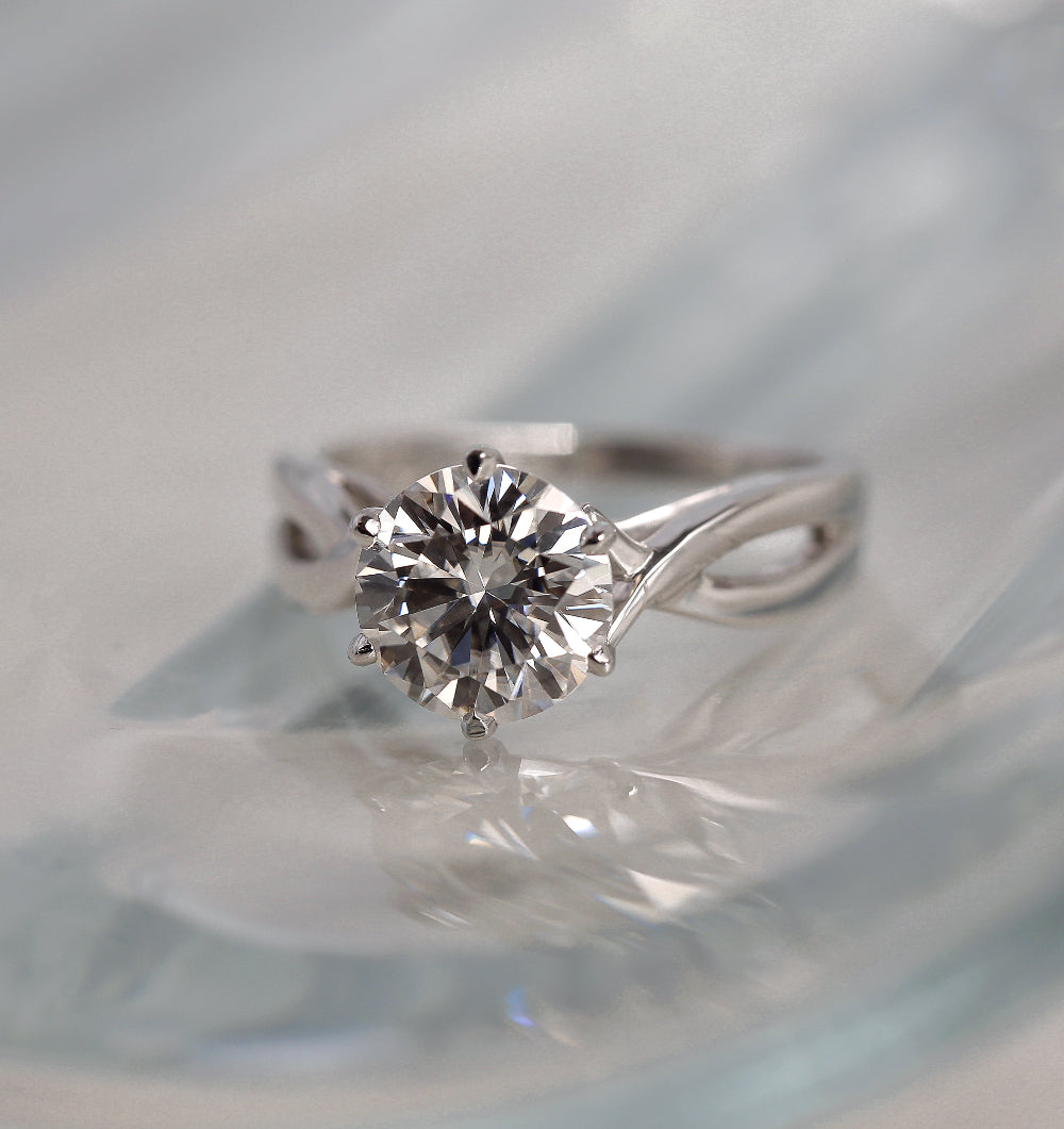 solitaire ring on a glass table