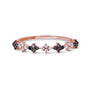 A rose gold fashion ring featuring alternating black and white diamond segments arranged in diamond-shaped square formations.