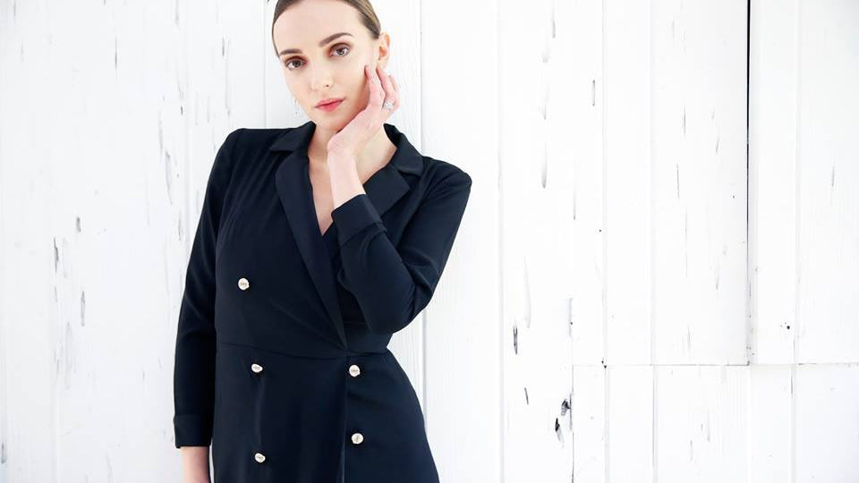 beautiful model in black coat wearing fine jewelry
