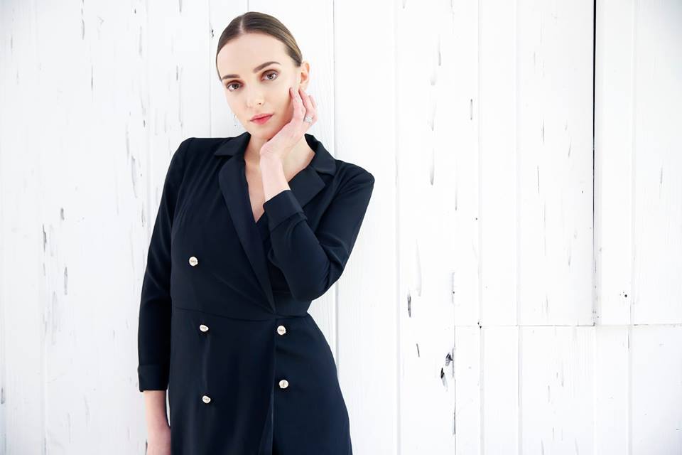 beautiful model in black coat wearing fine jewelry