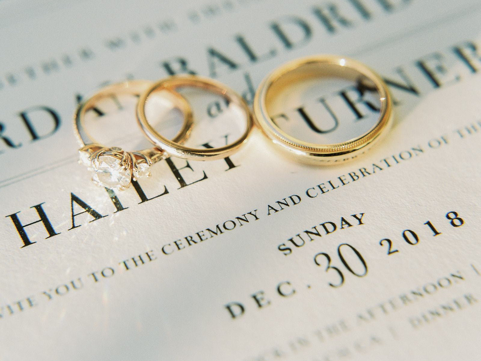 yellow gold diamond engagement ring and a pair of wedding bands