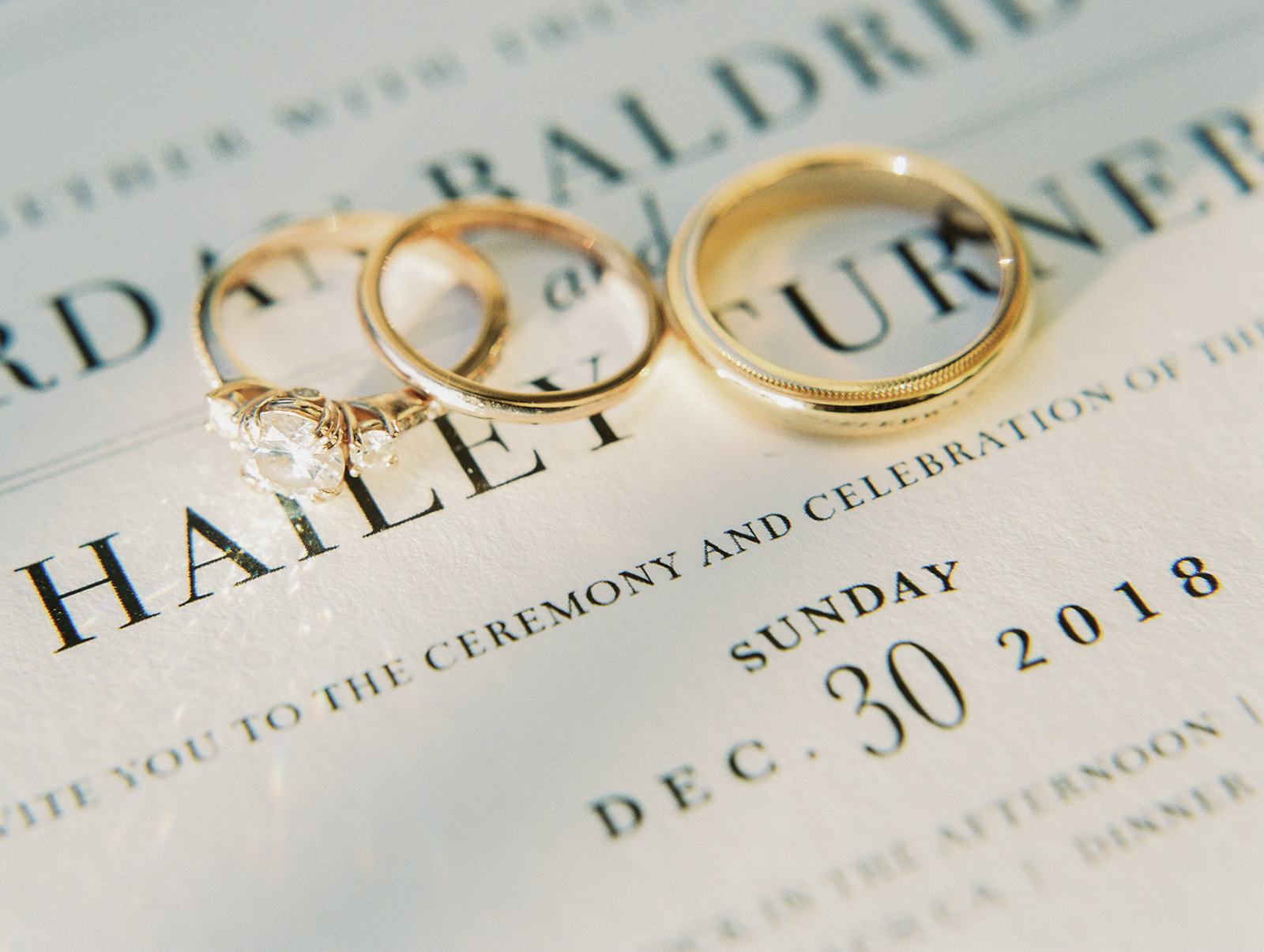 yellow gold diamond engagement ring and a pair of wedding bands