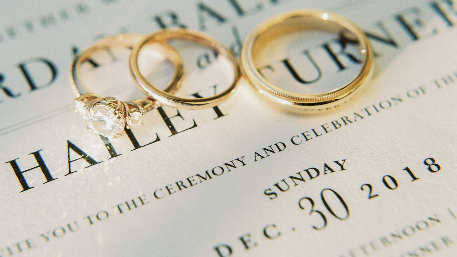 yellow gold diamond engagement ring and a pair of wedding bands