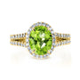 oval green peridot gemstone with white diamond halo and diamond lined split shank in 14k yellow gold