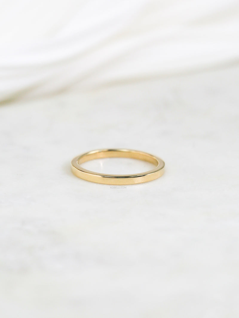 2mm Cigar Band by Kobelli in Yellow Gold flatlay