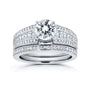 A wide white gold diamond engagement ring with a round-cut center diamond and a matching diamond band