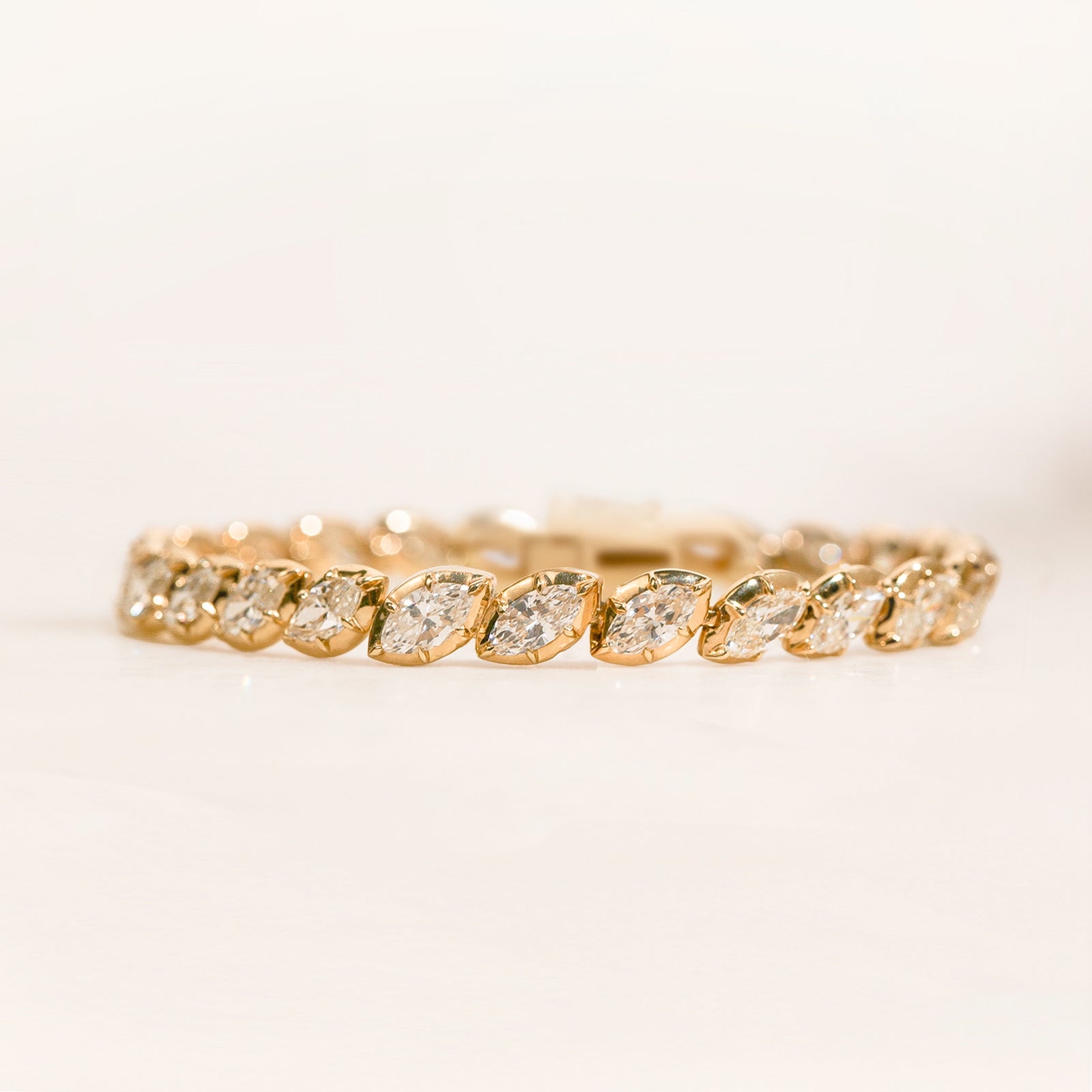 8+ Carat Diamond Collet Tennis Hira Bracelet - lifestyle image on a light beige surface