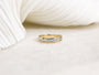 round brilliant white diamonds are set between two layers of gold 