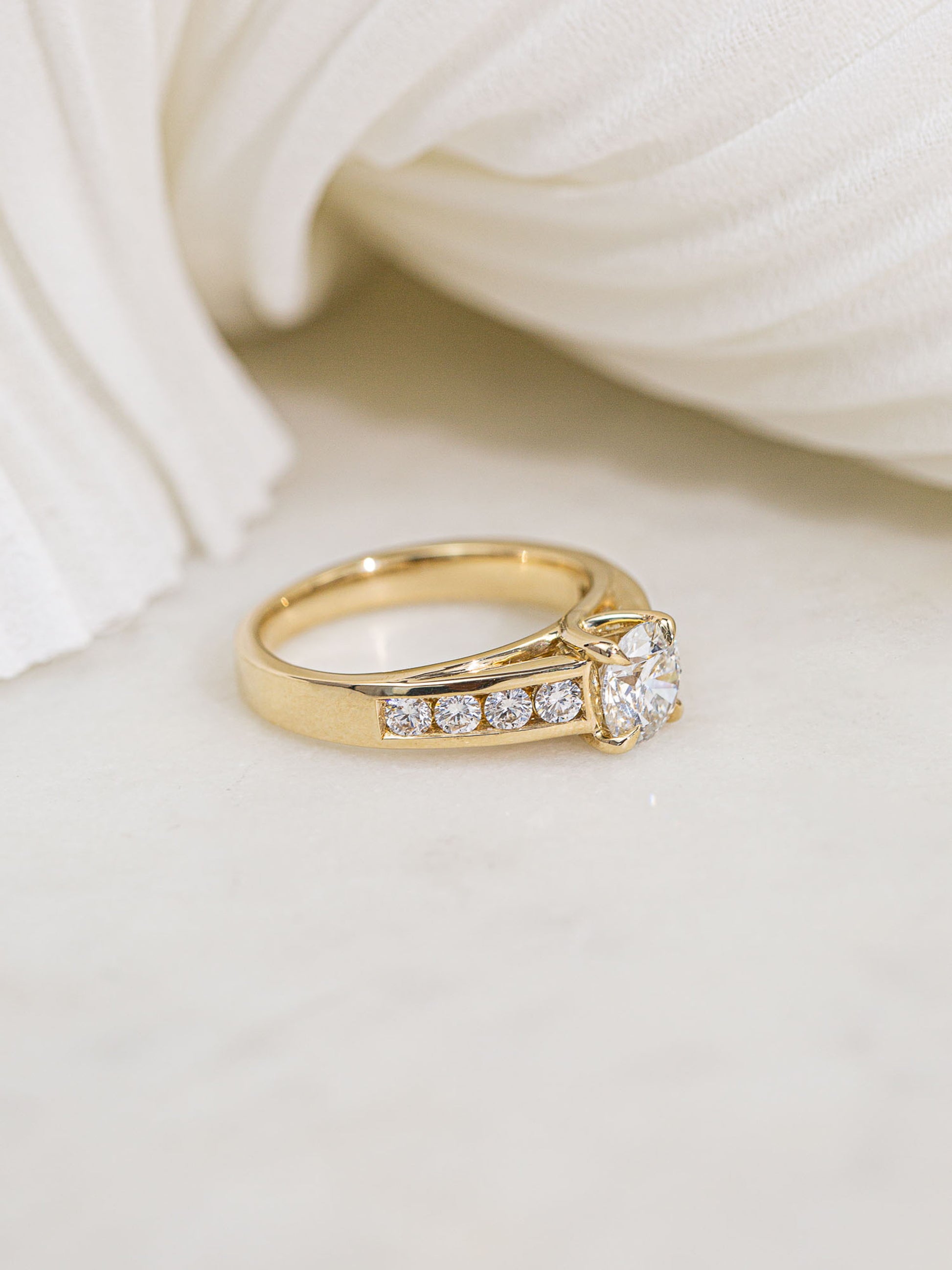 lifestyle image for a better picture of what the ring will look like - 8 diamonds line the band partway down the top surface