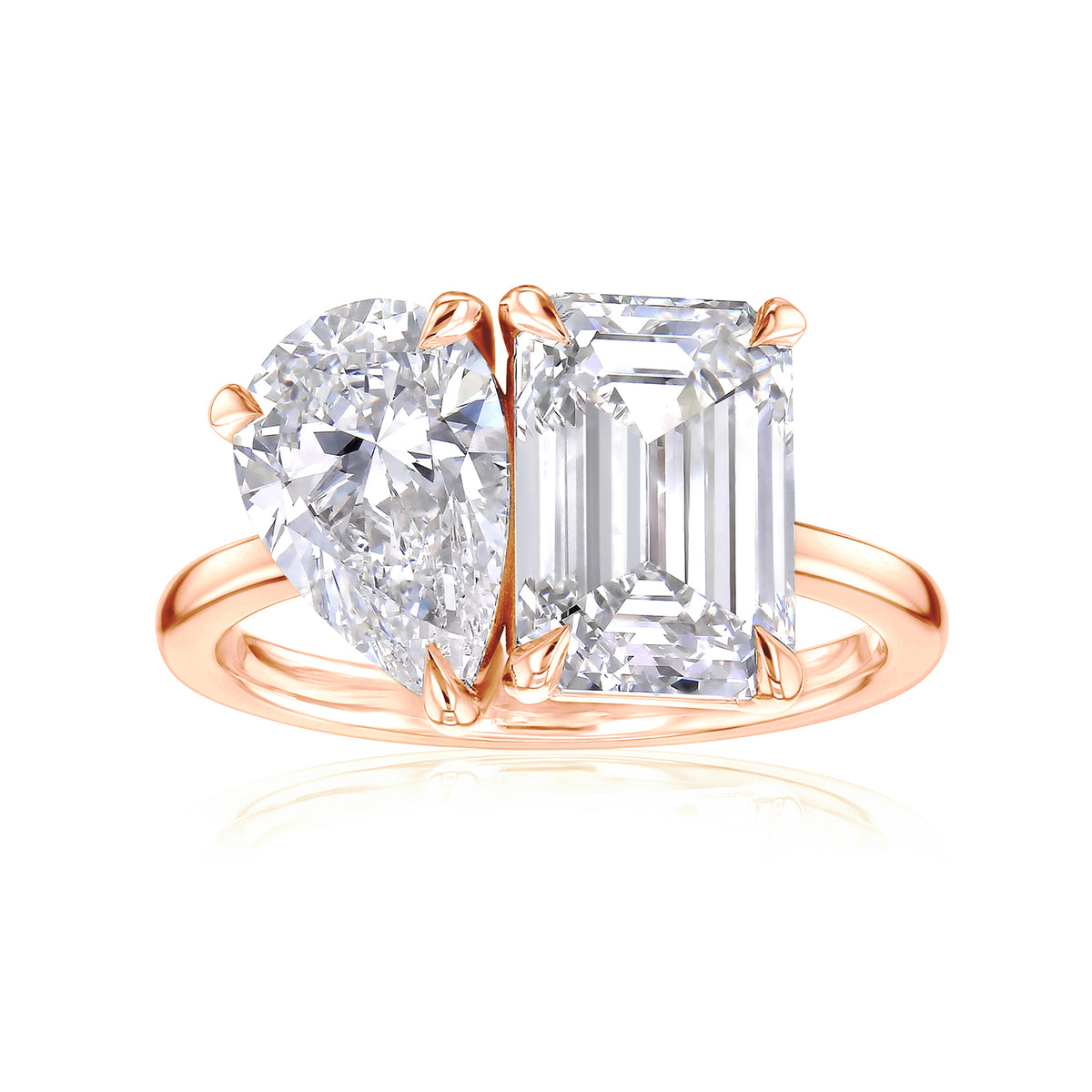 toi et moi ring with two large diamonds, one rectangular shape emerald step-cut, and one pear shape brilliant-cut in rose gold