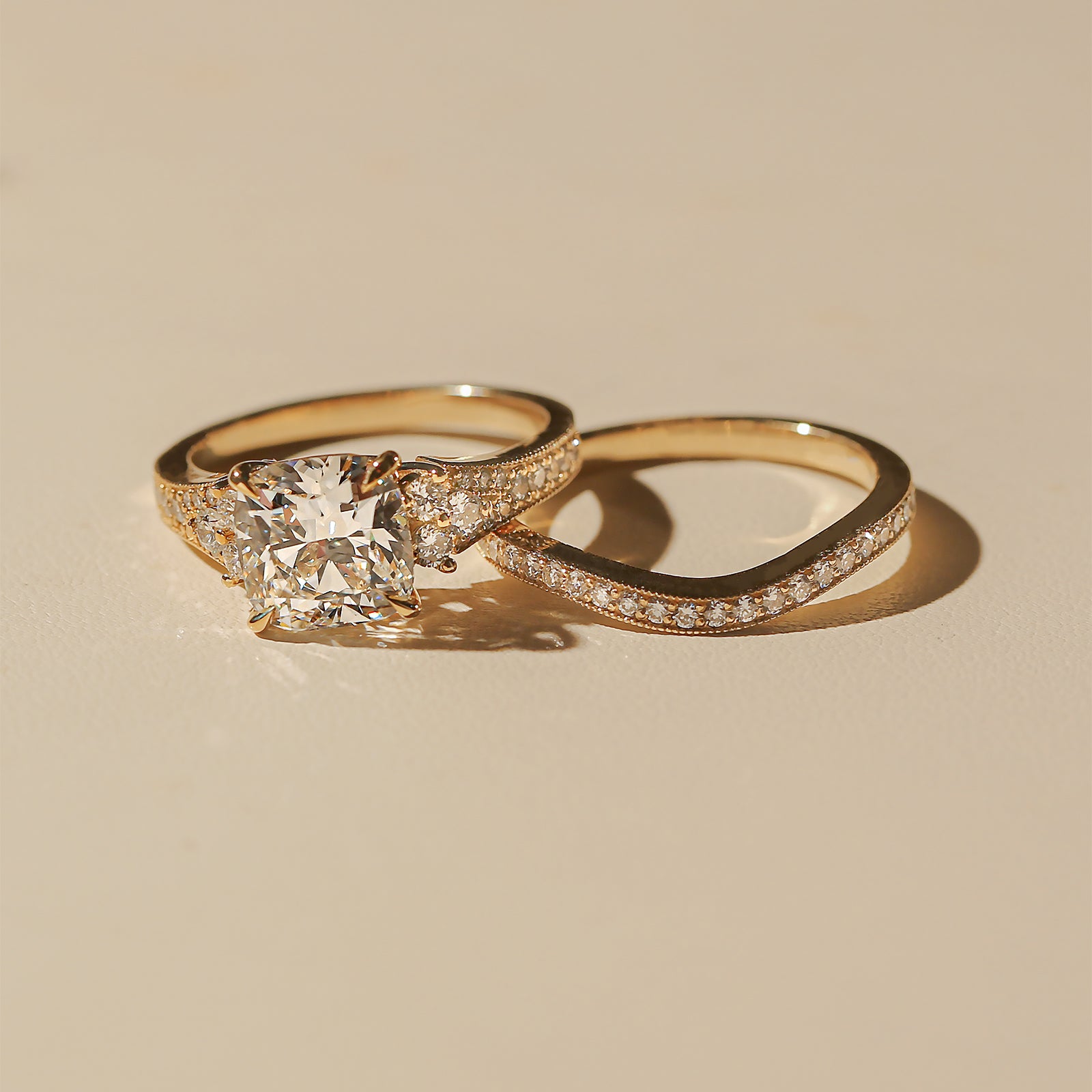 Lifestyle image of the Kobelli Grindelwald 2 Piece Bridal Set - Showcases a large cushion brilliant-cut center diamond and pavé-set accent diamonds in solid 14-karat gold - yellow gold option in size 7.5, 3 carat center diamond