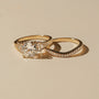 Lifestyle image of the Kobelli Grindelwald 2 Piece Bridal Set - Showcases a large cushion brilliant-cut center diamond and pavé-set accent diamonds in solid 14-karat gold - yellow gold option in size 7.5, 3 carat center diamond