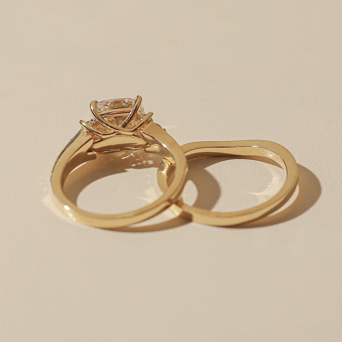 Lifestyle image of the Kobelli Grindelwald 2 Piece Bridal Set - backside angle showcasing the depth and setting - yellow gold option in size 7.5, 3 carat center diamond