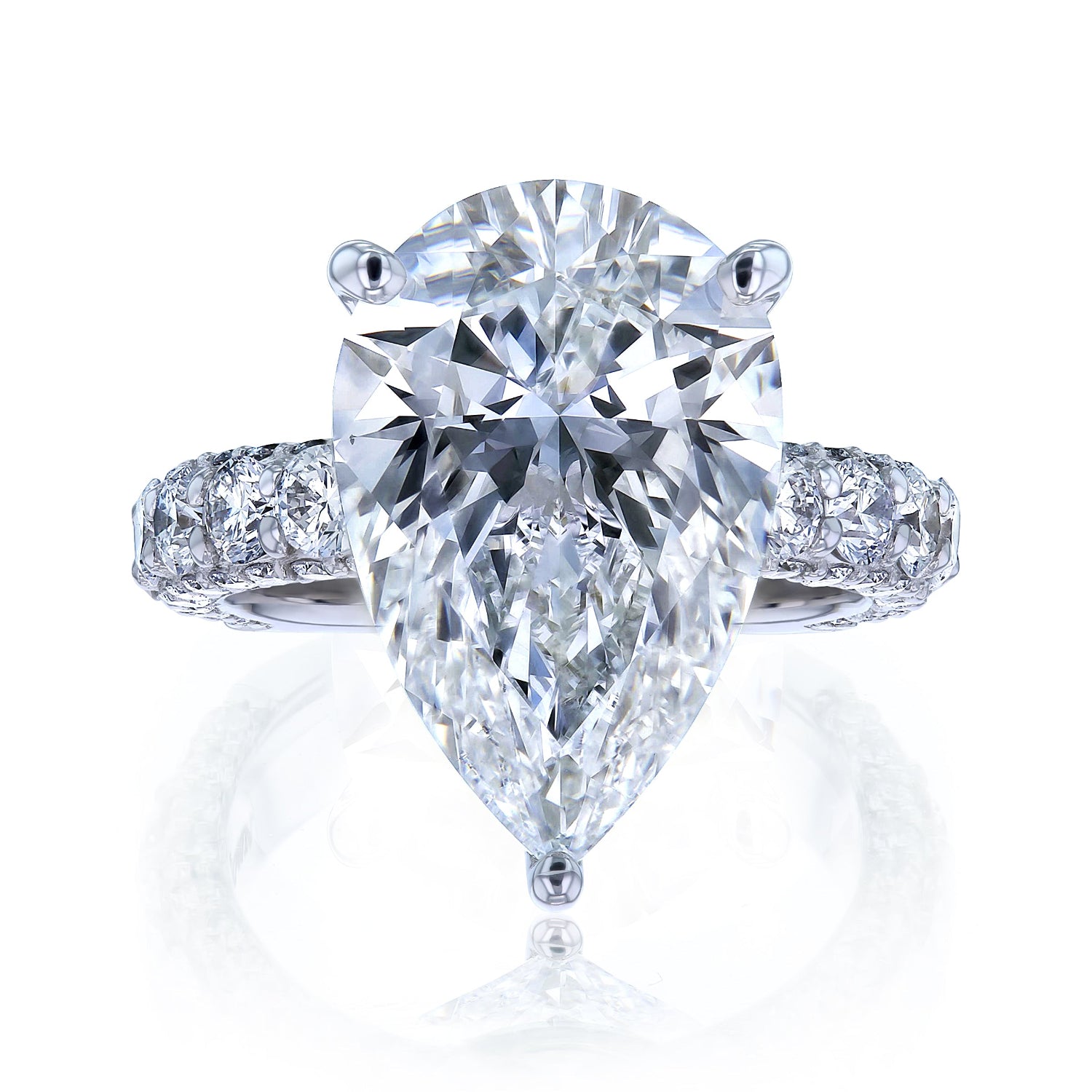 The Beckham Ring in White Gold - massive pear-cut white diamond center stone with multiple rows of round white diamonds lining the band