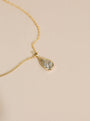 Pendant strung to gold chain