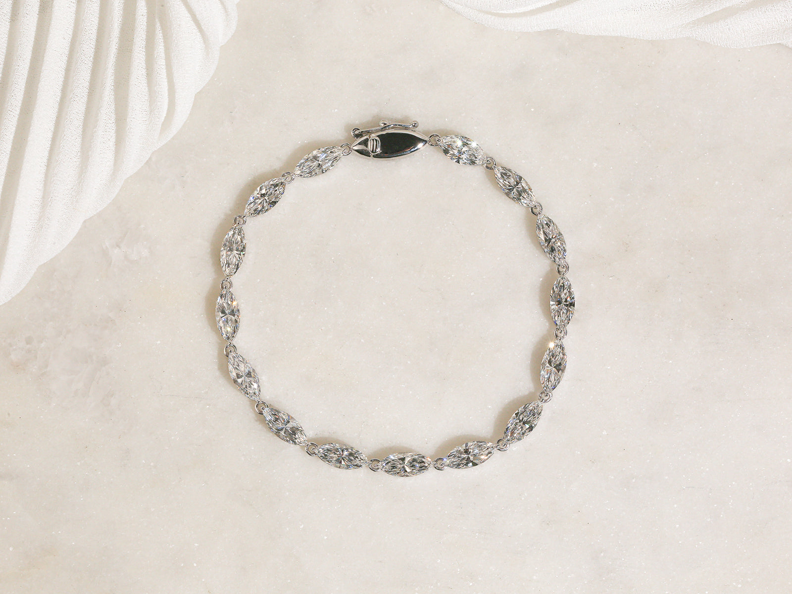 marquise brilliant-cut tennis bracelet laid flat on a white table
