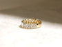 lifestyle image of ring on white table sitting under diffused sunlight