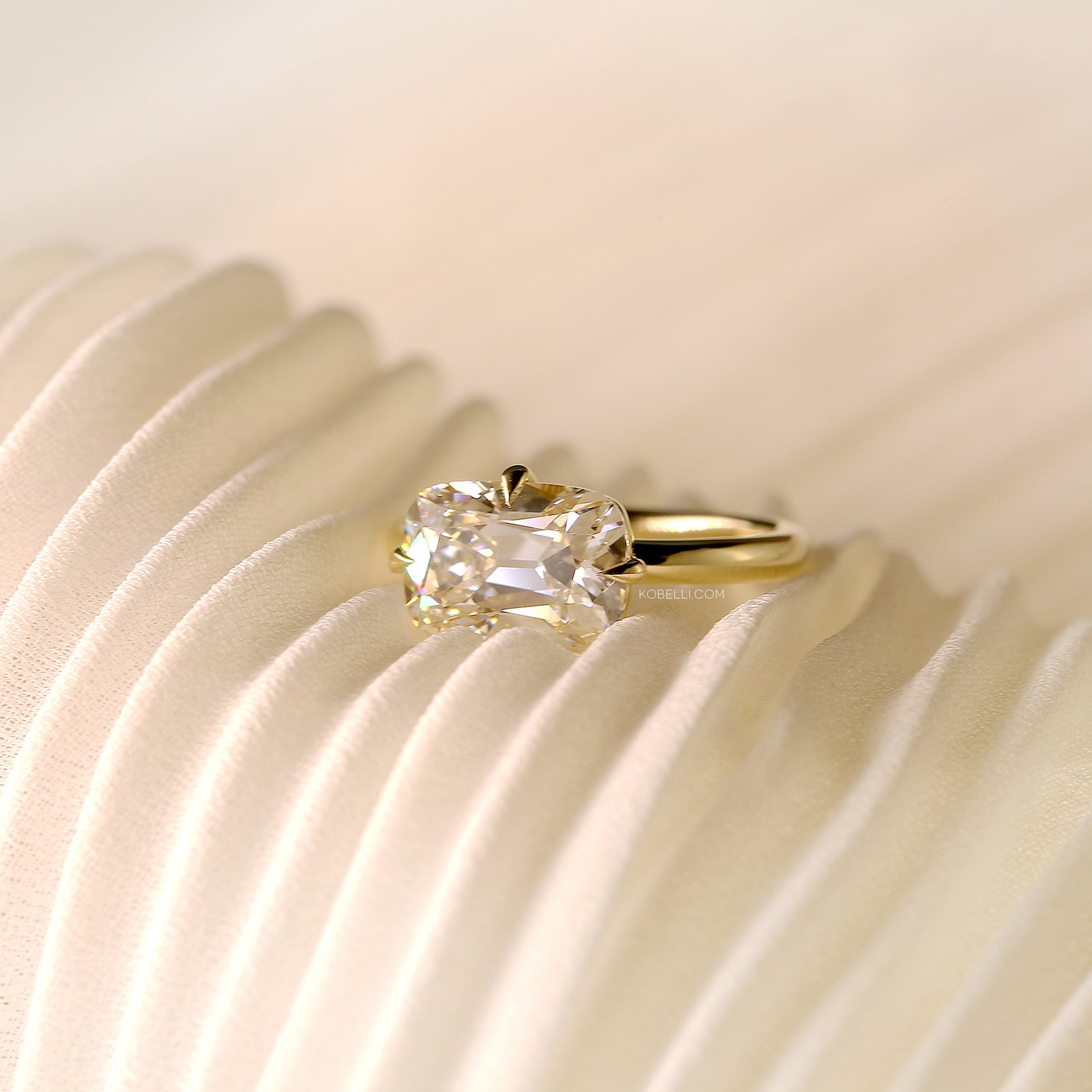 Kobelli Old Mine Lab Grown Diamond Plain Band Ember Ring in Yellow Gold - lifestyle shot of ring sitting on white pleated fabric