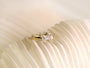 lifestyle image of Kobelli's east-west old mine cut diamond ring sitting atop a pleated white fabric