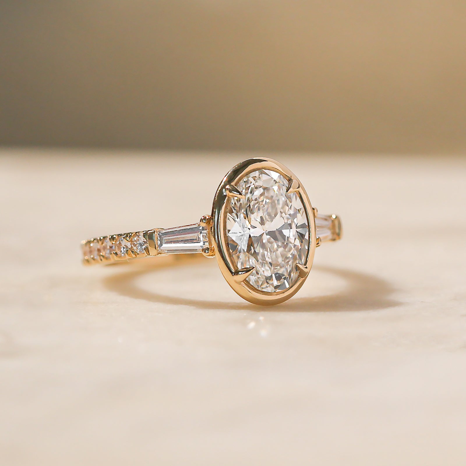 Kobelli Sona Ring - slight side angle laying on a tabletop in warm light