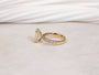 Simple floating basket prong setting over a diamond band