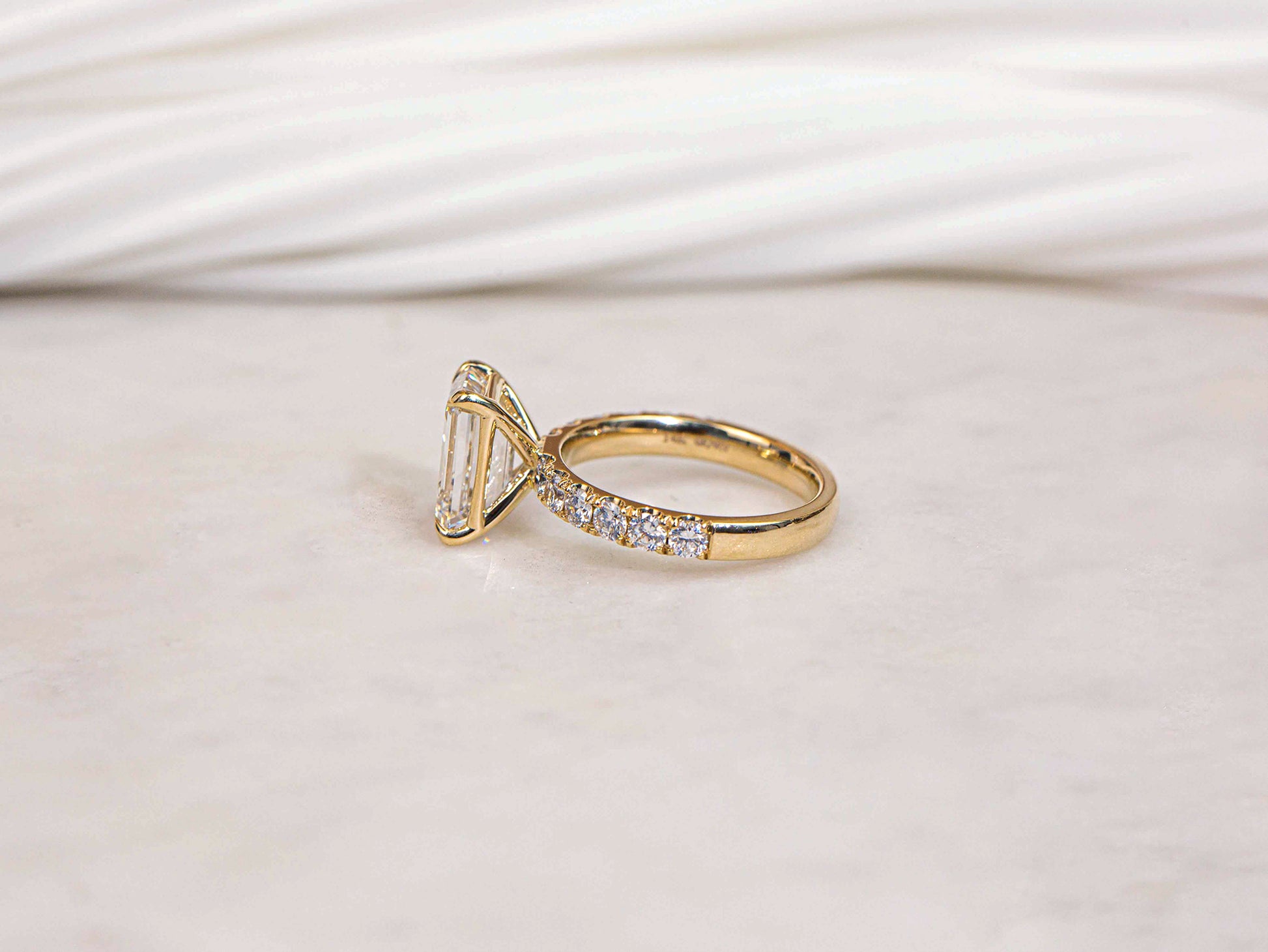 Simple floating basket prong setting over a diamond band