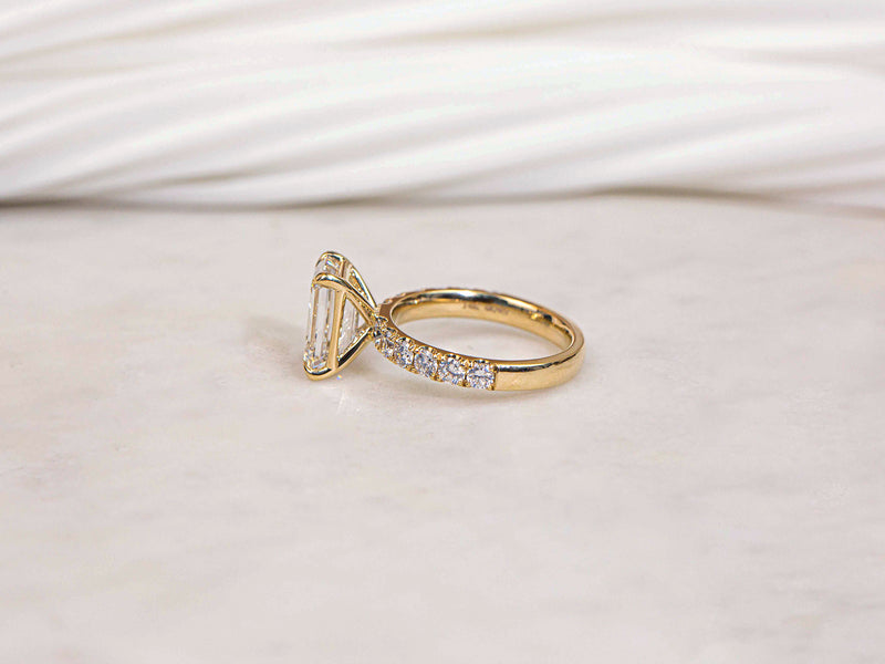 Simple floating basket prong setting over a diamond band