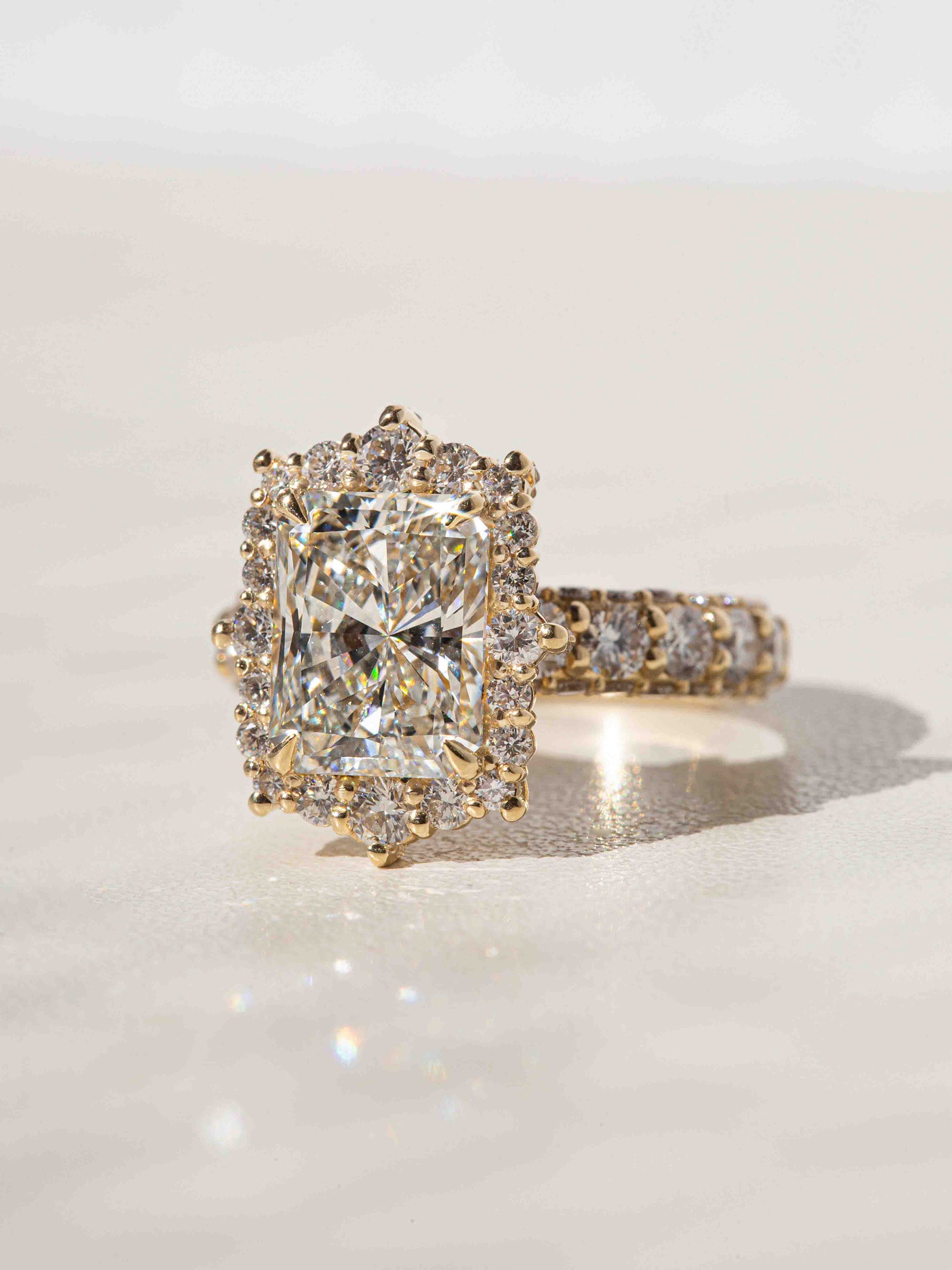 Brilliant facets on the radiant and round diamonds offer optimal sparkles