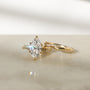 3.25 Carat Lab Grown Diamond Marquise Shifting Helix Ring paired to the Shifting Helix Wedding Band Ring - front angle resting on a white table