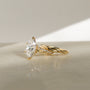 3.25 Carat Lab Grown Diamond Marquise Shifting Helix Ring paired to the Plain Helix Wedding Band Ring - side angle resting on a white table