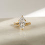 3.25 Carat Lab Grown Diamond Marquise Shifting Helix Ring - front angle resting on a marbled white table