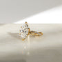 3.25 Carat Lab Grown Diamond Marquise Shifting Helix Ring - side angle resting on a marbled white table