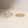 3.5 Carat Lab Grown Diamond Marquise Double Helix Ring Solid 14k Yellow Gold Matched to the Double Helix Wedding Band - lifestyle image resting on a table in indirect sunlight