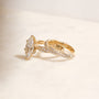 3.5 Carat Lab Grown Diamond Marquise Double Helix Ring Solid 14k Yellow Gold paired to the Diamond Double Helix Wedding Band - lifestyle image resting on a white surface