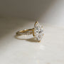 3.5 Carat Lab Grown Diamond Marquise Double Helix Ring Solid 14k Yellow Gold - lifestyle image resting on a table in indirect sunlight