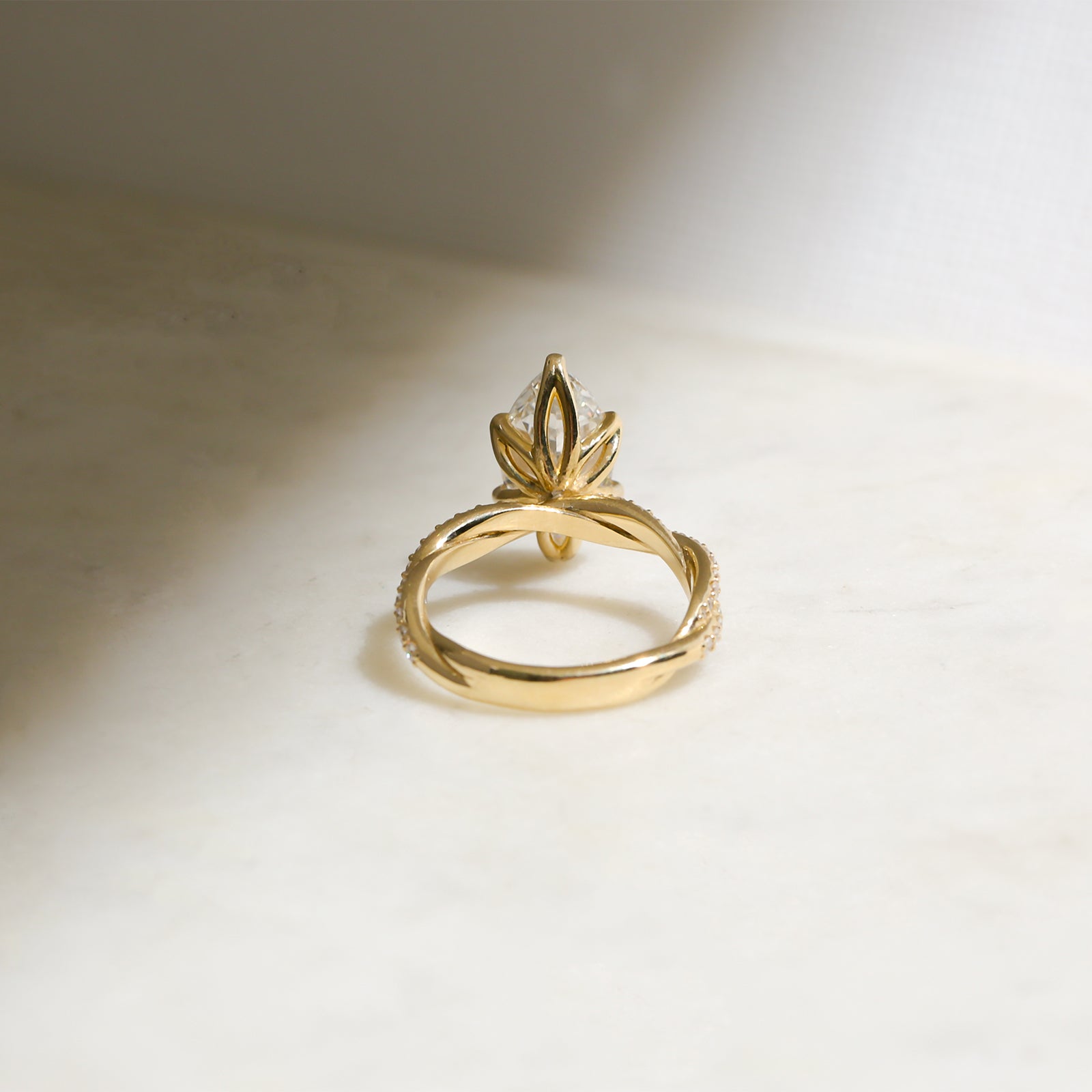 backside angle of the ring to showcase the lotus prong setting