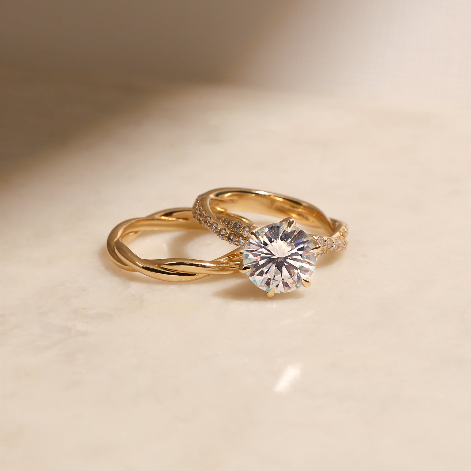 lifestyle image of the Round Diamond Double Helix Engagement Ring sitting over the Plain Helix Wedding Band