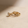 lifestyle image of the Round Diamond Double Helix Engagement Ring sitting under the Plain Helix Wedding Band, shot at a full side angle