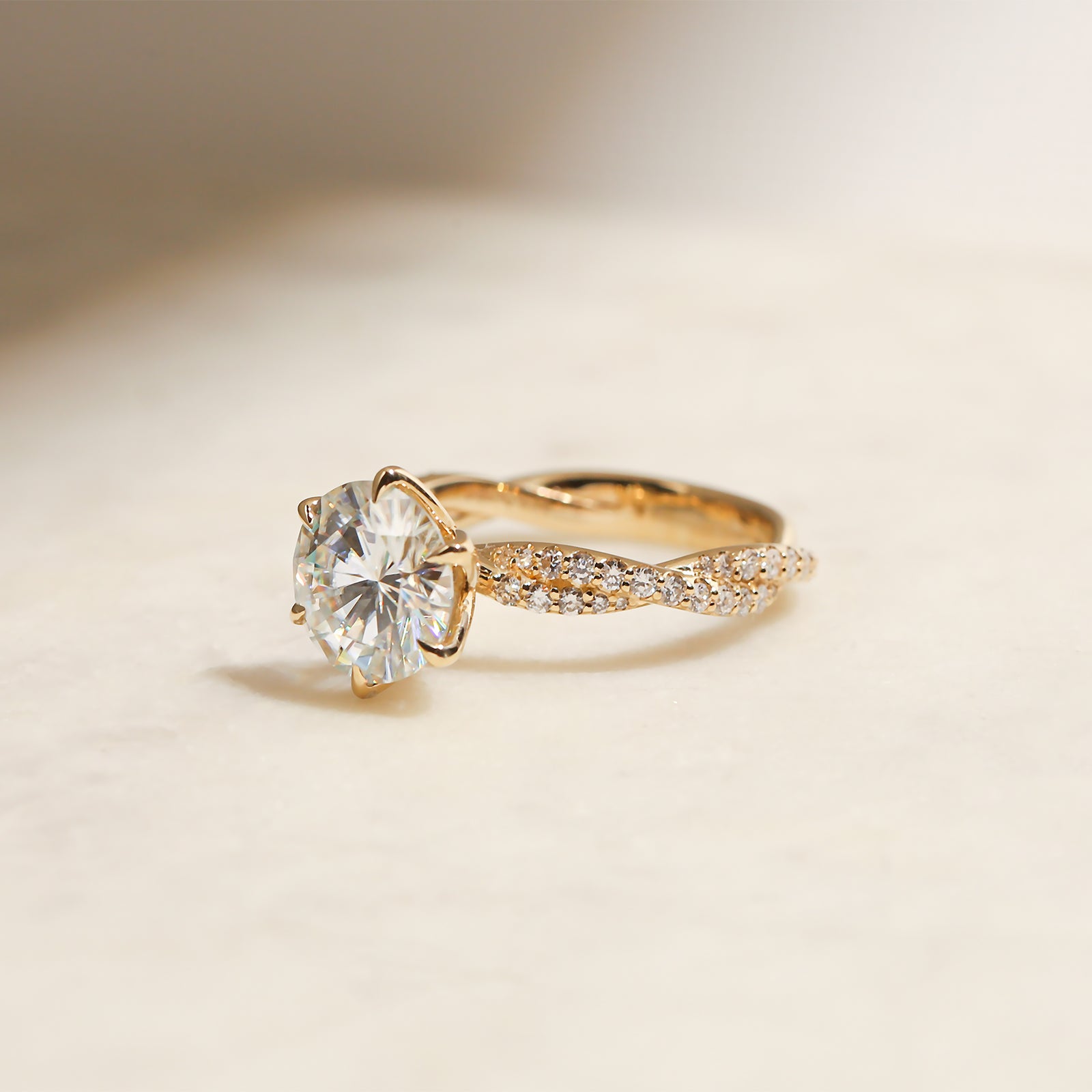 lifestyle image, shot at a semi-side angle, of Kobelli's Double Helix Round Diamond Ring in yellow gold