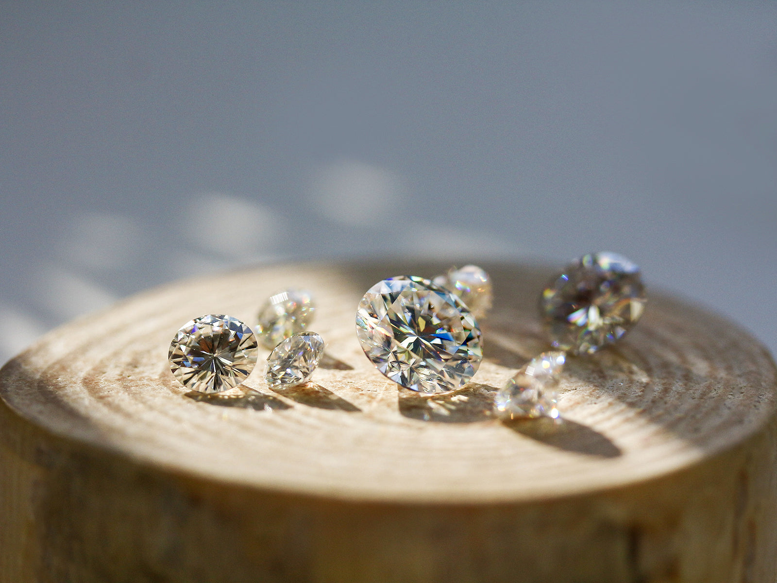 round brilliant colorless stones on wooden surface