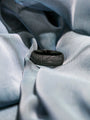Champion Charcoal Black Ring sitting on gray fabric