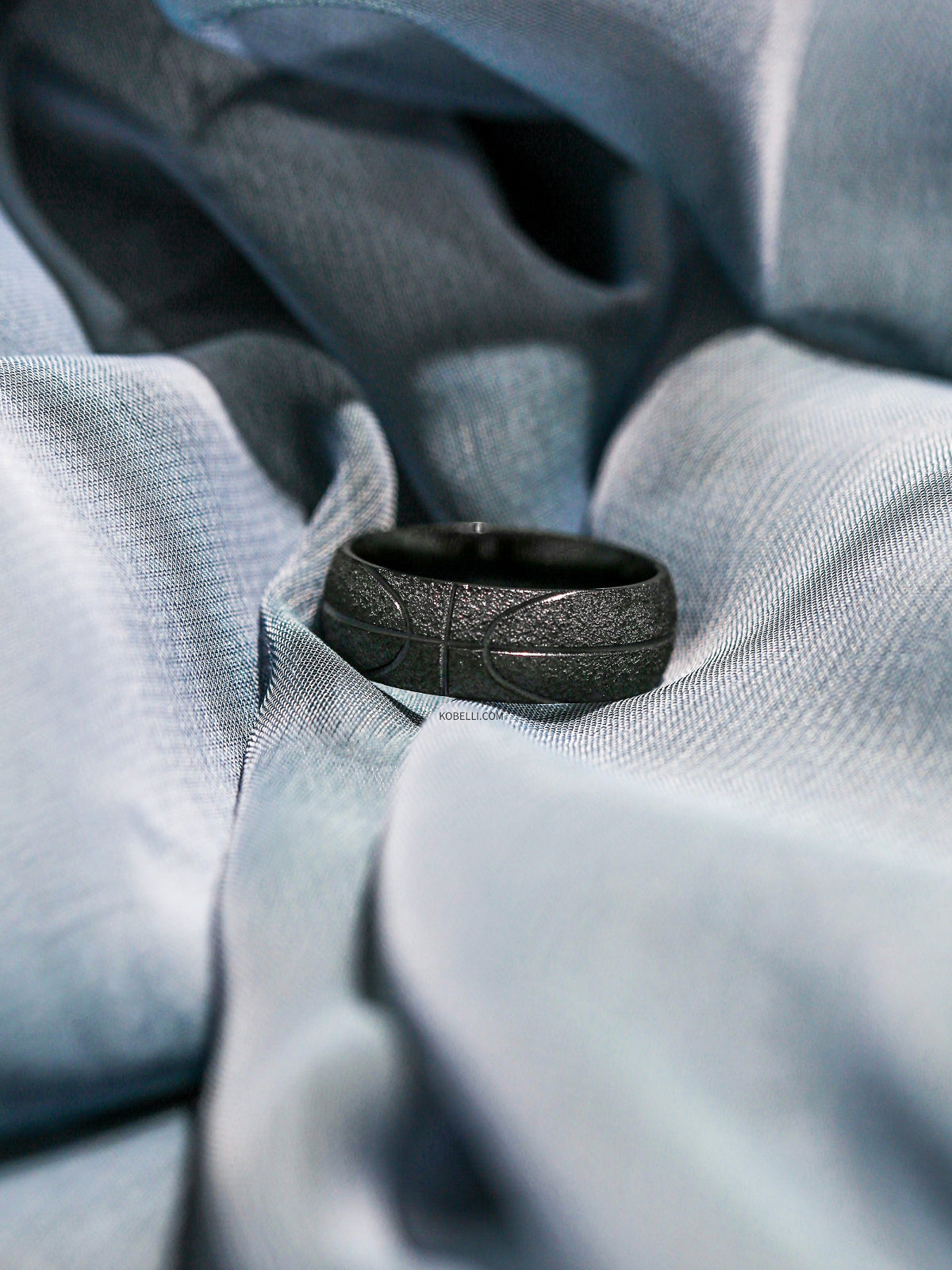 Champion Charcoal Black Ring sitting on gray fabric