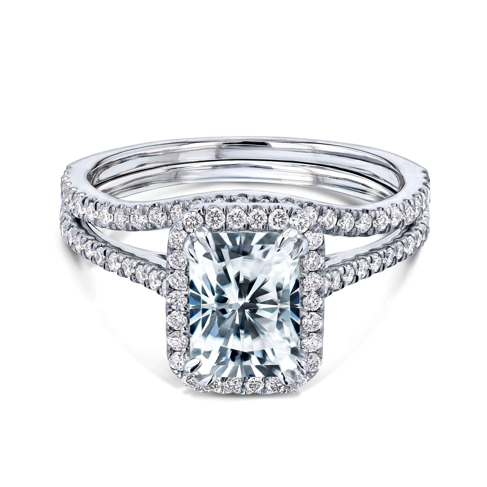 radiant-cut moissanite center with diamond side stones forming to a halo over a near eternity band in 14k white gold + a matching contoured wedding band that flows outwards under the center setting
