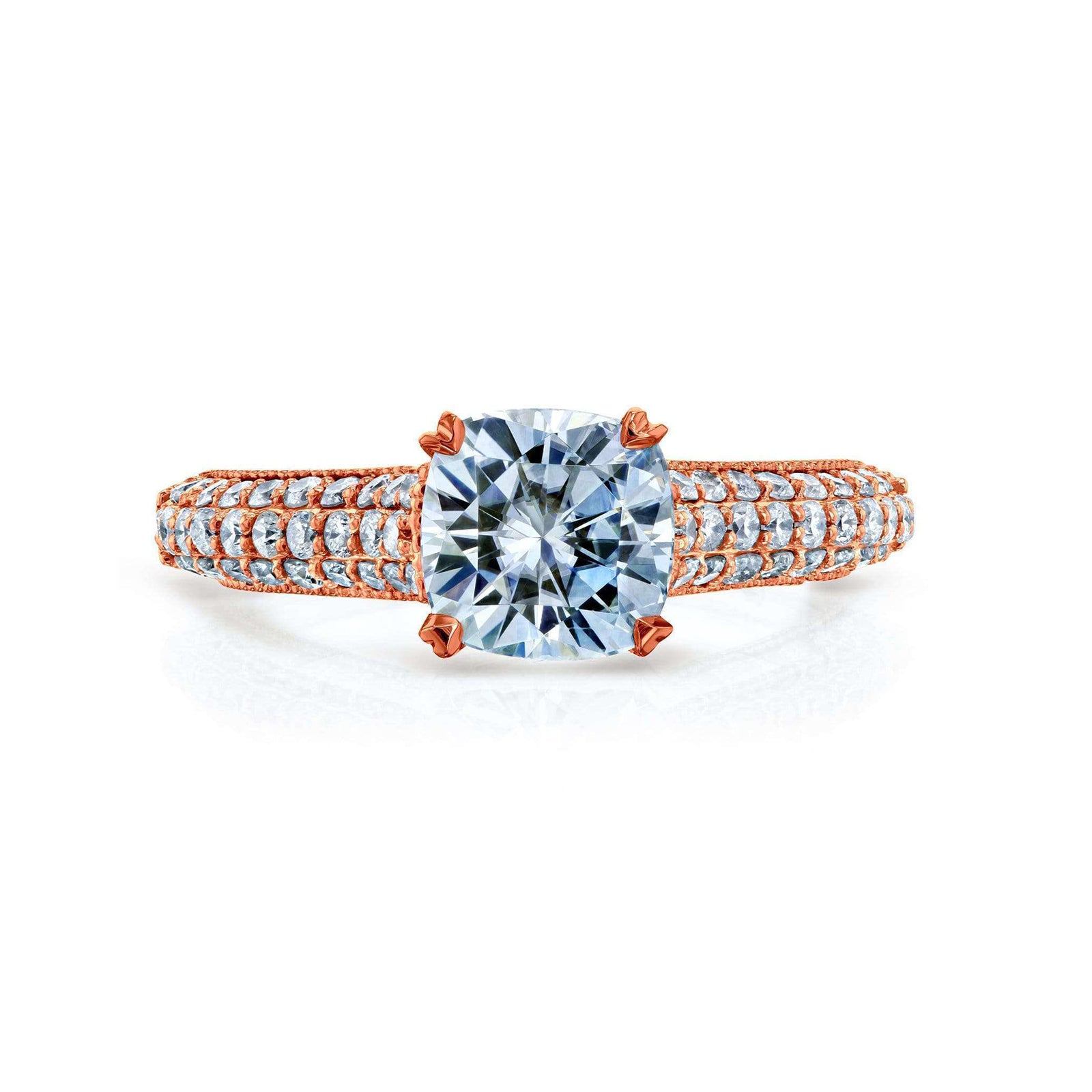 A yellow gold ring featuring a large cushion-cut center in a four-prong setting, with pavé-set small clear stones along the shoulders of a split band, shown on a white background.
