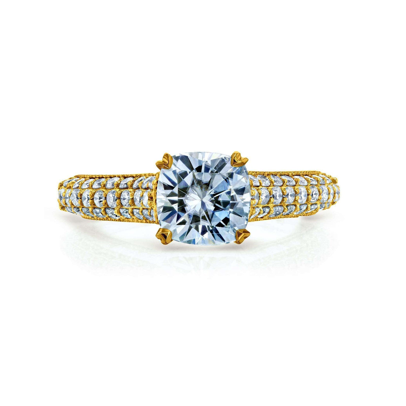 A yellow gold ring featuring a large cushion-cut center in a four-prong setting, with pavé-set small clear stones along the shoulders of a split band, shown on a white background.