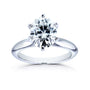 A classic solitaire engagement ring featuring a round brilliant-cut moissanite set in a polished white gold band