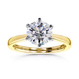 6 prongs carry a 2 carat round center in yellow gold