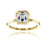 white-background image of 1.5 carat Asscher bezel-set in yellow gold