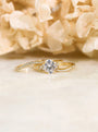 side cluster engagement ring and two curved wedding bands